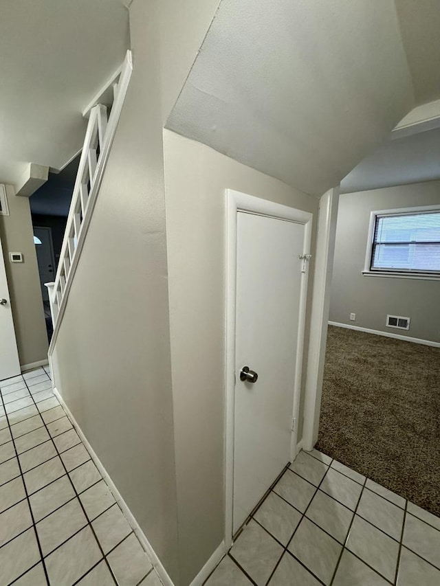 stairs featuring carpet floors and lofted ceiling