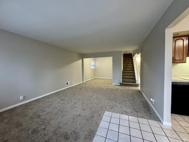 unfurnished living room featuring light carpet