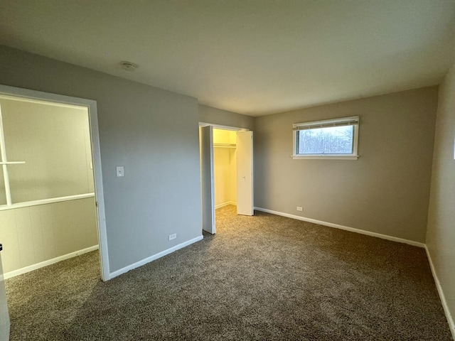 unfurnished bedroom with dark carpet