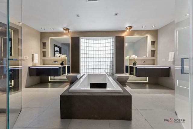 interior space featuring a bath, vanity, tile patterned floors, and built in shelves