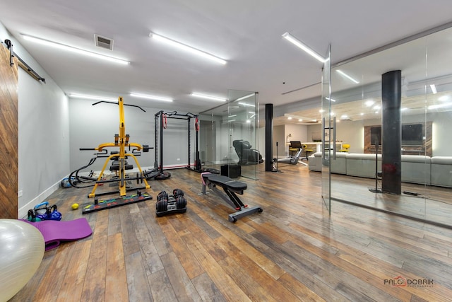 exercise room with wood-type flooring