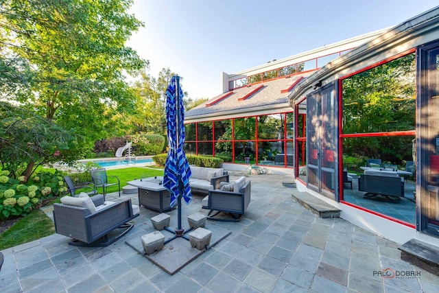 view of patio / terrace with an outdoor living space and a swimming pool