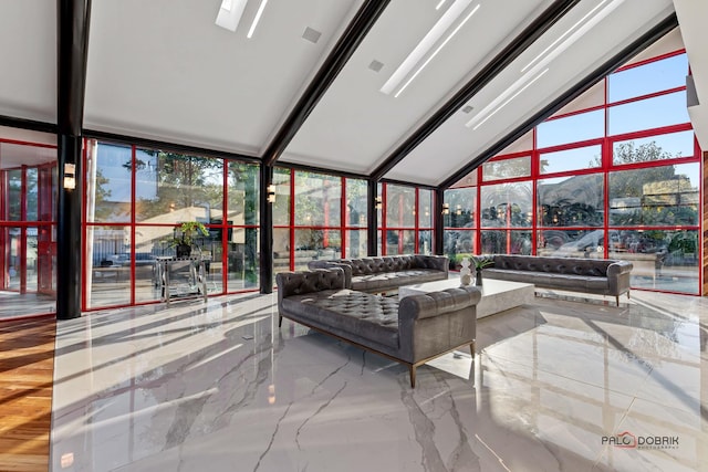 sunroom / solarium featuring a mountain view and lofted ceiling with skylight