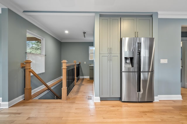 kitchen featuring light hardwood / wood-style floors, stainless steel refrigerator with ice dispenser, and ornamental molding