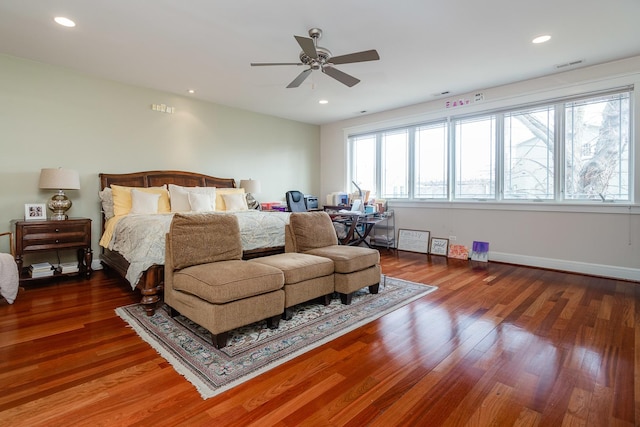 bedroom with dark hardwood / wood-style flooring and ceiling fan