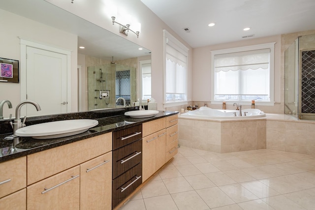 bathroom with tile patterned flooring, vanity, and independent shower and bath