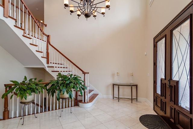 entrance foyer featuring a notable chandelier and a towering ceiling