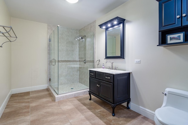 bathroom featuring vanity, toilet, and a shower with door