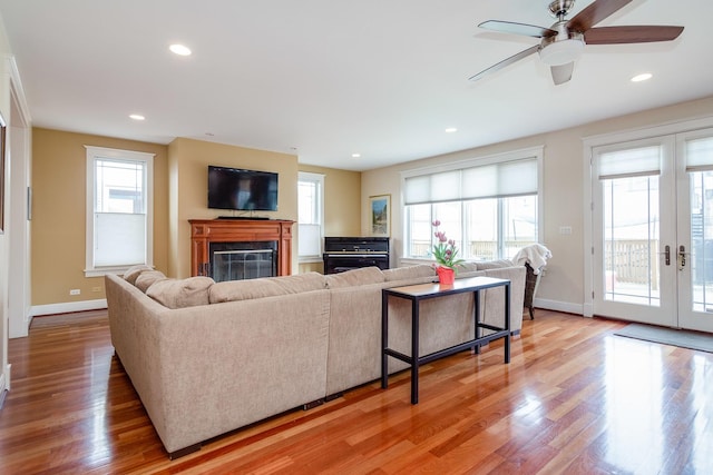 living room with wood-type flooring, french doors, and ceiling fan