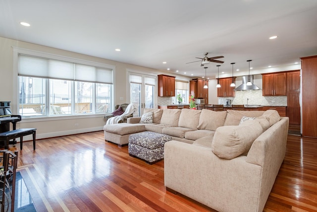 living room featuring wood-type flooring and plenty of natural light