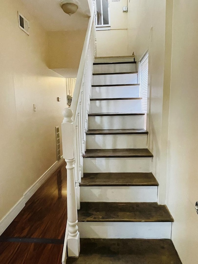 staircase featuring hardwood / wood-style floors