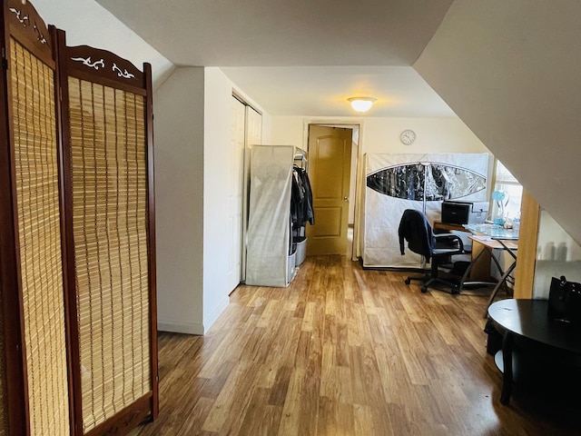 office area featuring hardwood / wood-style floors and vaulted ceiling