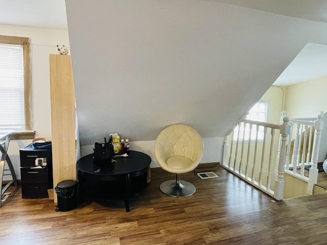 living area featuring wood-type flooring and lofted ceiling