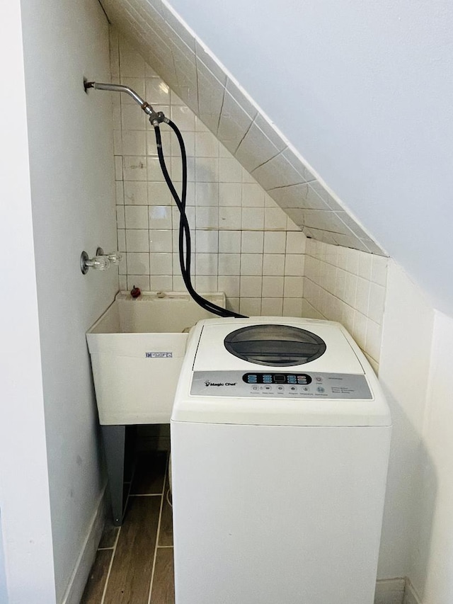 laundry room featuring washer / clothes dryer and dark wood-type flooring