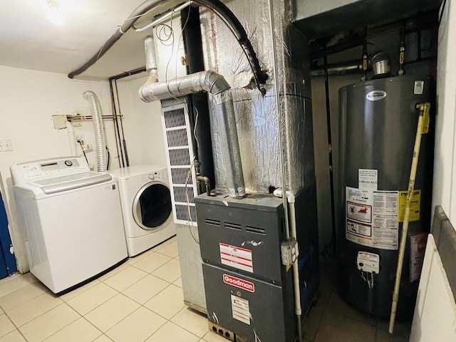 washroom featuring gas water heater, independent washer and dryer, and light tile patterned floors