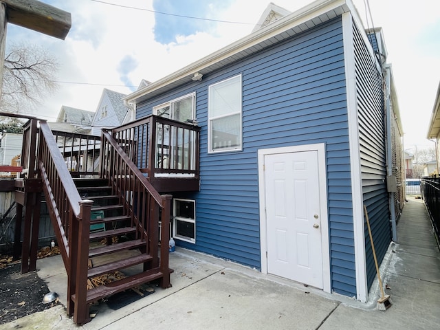 rear view of property featuring a patio and a wooden deck