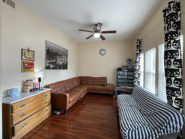 living room with ceiling fan and dark wood-type flooring