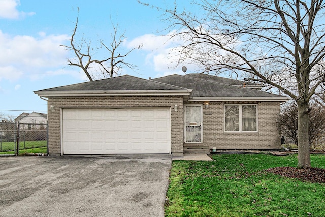 ranch-style home with a front lawn and a garage