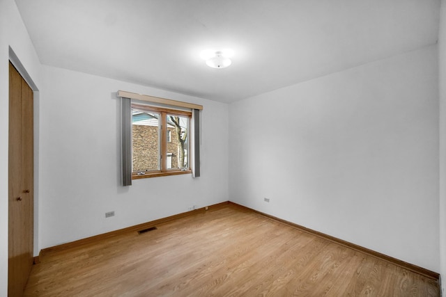 interior space with light wood-type flooring and a closet