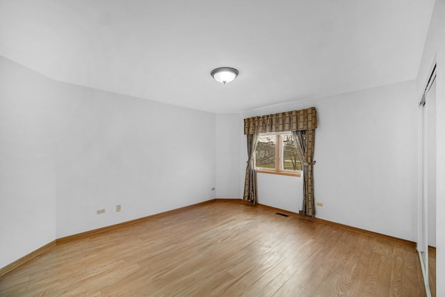 spare room featuring light wood-type flooring