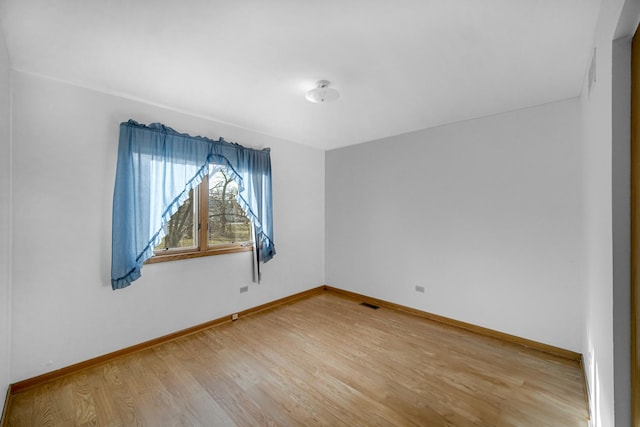 spare room featuring light hardwood / wood-style floors