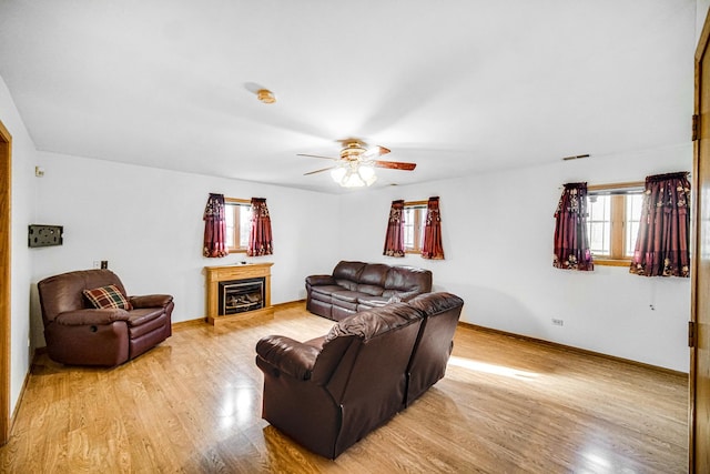 living room featuring ceiling fan and light wood-type flooring