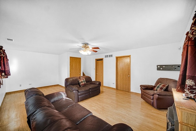 living room featuring hardwood / wood-style flooring and ceiling fan