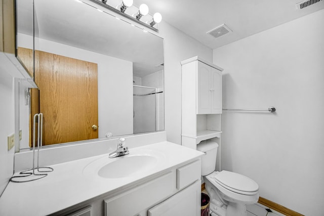 bathroom with vanity, toilet, and walk in shower