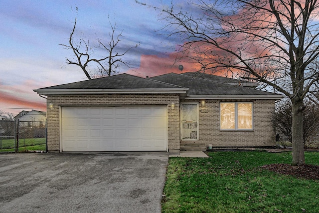 view of front of property featuring a yard and a garage