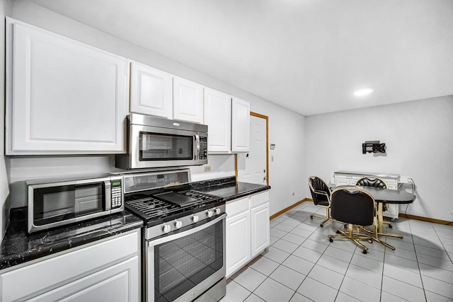 kitchen with white cabinetry, stainless steel appliances, and light tile patterned floors