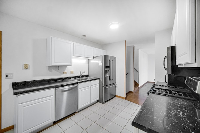 kitchen with white cabinetry, sink, stainless steel appliances, and light wood-type flooring