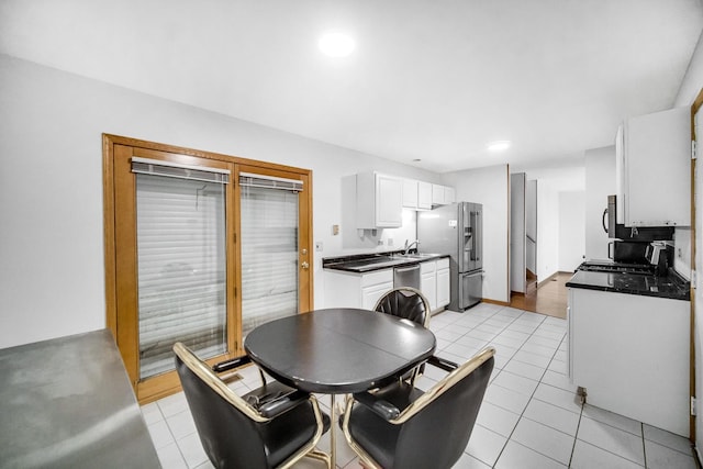 dining area with light tile patterned floors and sink