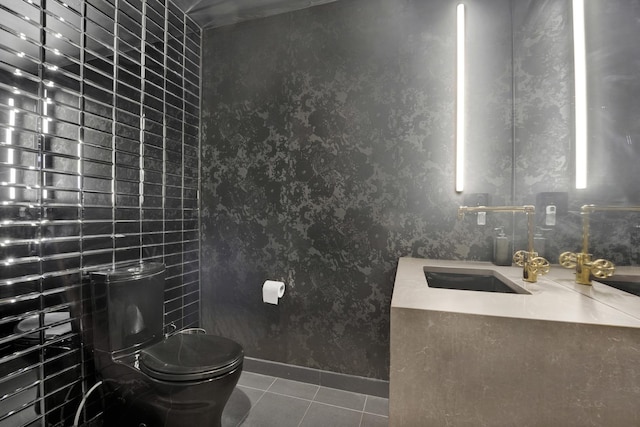 bathroom featuring sink, toilet, and tile patterned floors