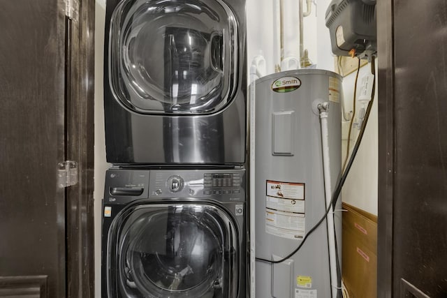 laundry room featuring stacked washer / dryer and electric water heater