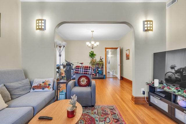 living room featuring a chandelier and hardwood / wood-style floors