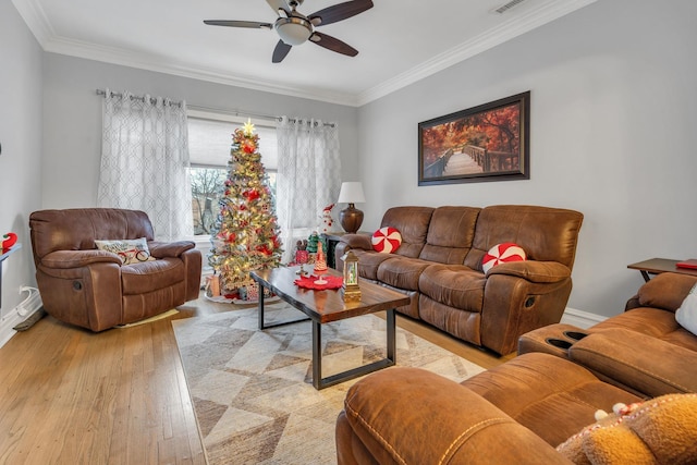 living room featuring crown molding, light hardwood / wood-style flooring, and ceiling fan