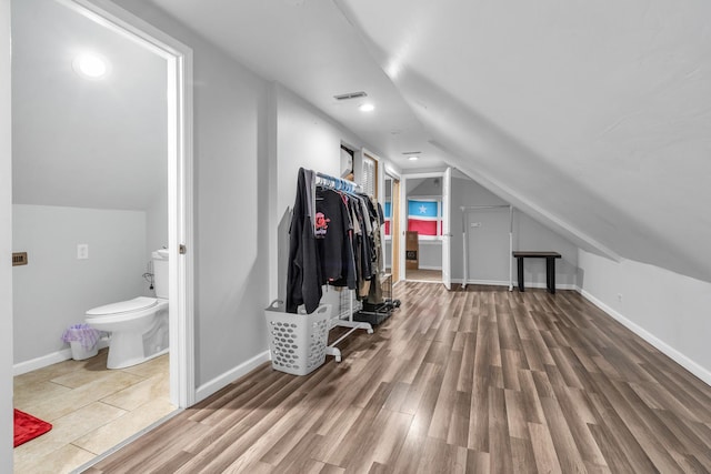 bonus room featuring lofted ceiling and hardwood / wood-style flooring