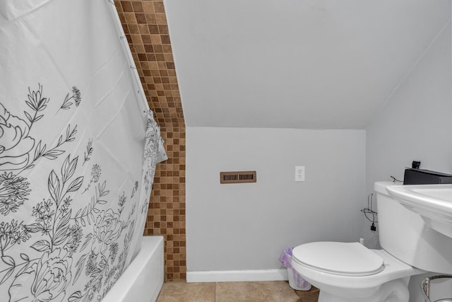 bathroom featuring shower / tub combo, tile patterned floors, toilet, and lofted ceiling