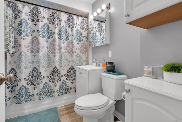 bathroom with vanity, toilet, and hardwood / wood-style floors