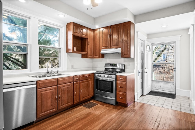 kitchen with hardwood / wood-style flooring, sink, ceiling fan, and appliances with stainless steel finishes