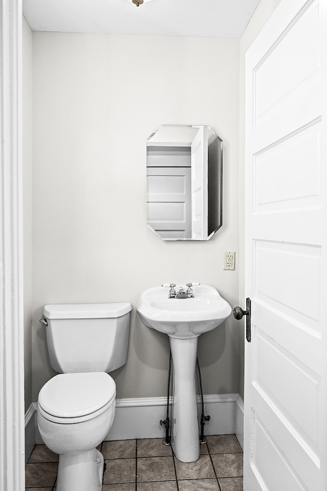 bathroom featuring tile patterned floors, toilet, and sink