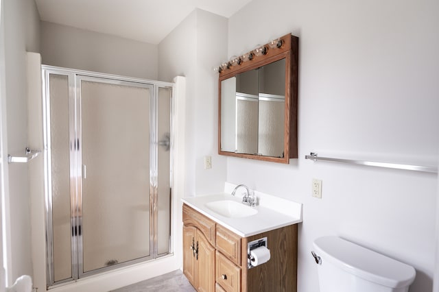 bathroom featuring vanity, toilet, and an enclosed shower