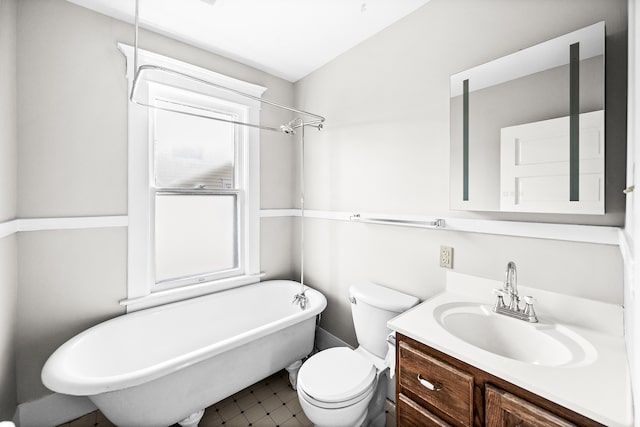 bathroom featuring vanity, toilet, and a bathing tub