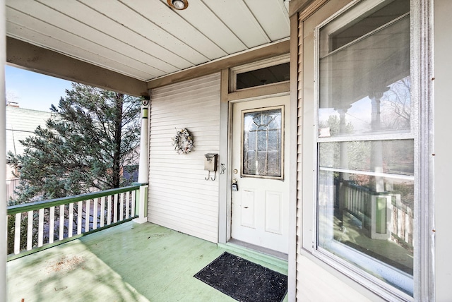 view of exterior entry featuring a porch