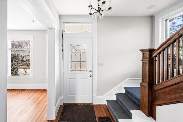 foyer featuring hardwood / wood-style floors and a chandelier