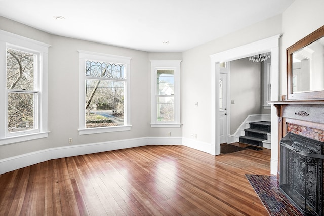 living room with hardwood / wood-style flooring and an inviting chandelier