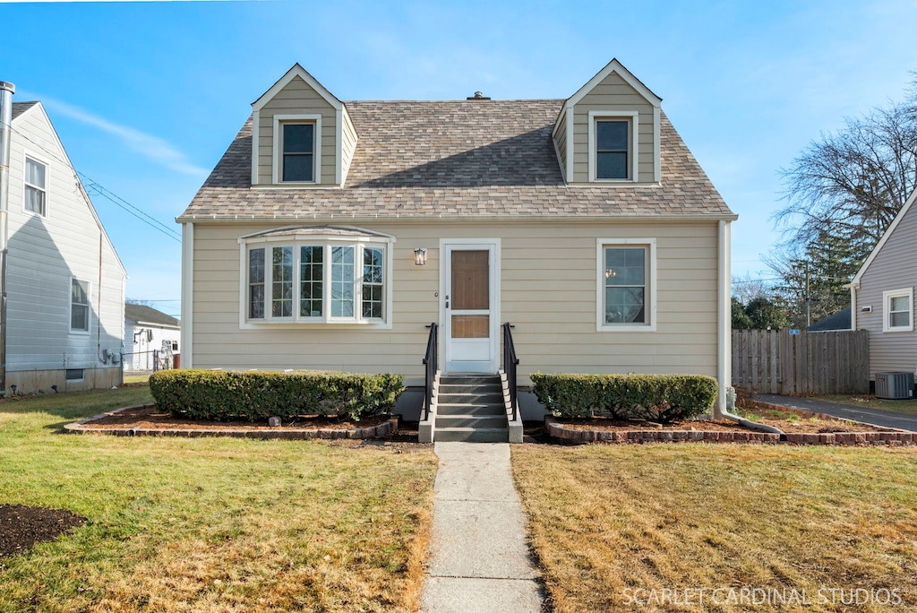 cape cod house with cooling unit and a front lawn