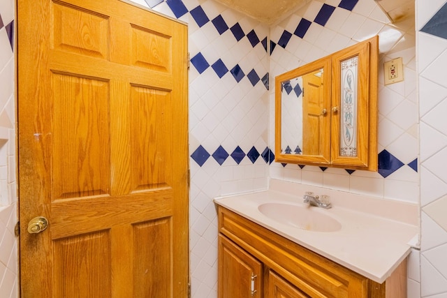 bathroom with vanity and tile walls