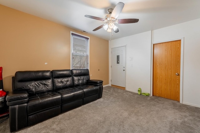 carpeted living room with ceiling fan