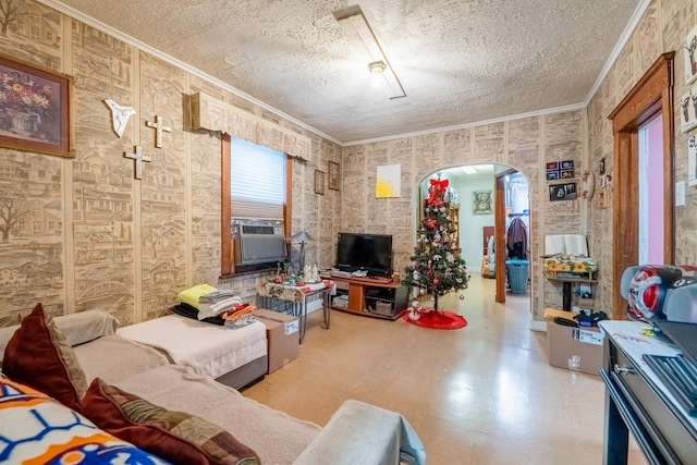 living room featuring cooling unit, a textured ceiling, and ornamental molding